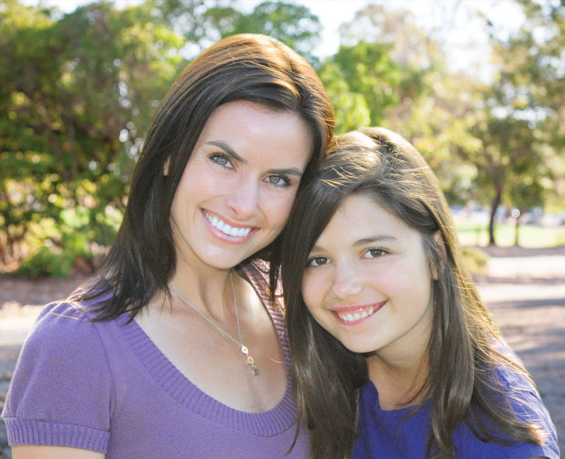 Mother and daughter smiling